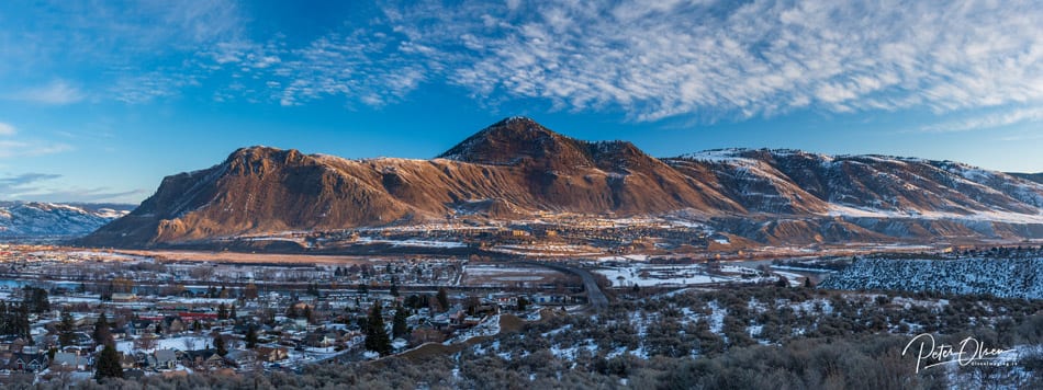 Kamloops City blue sky with white clouds and mountain with grass and snow