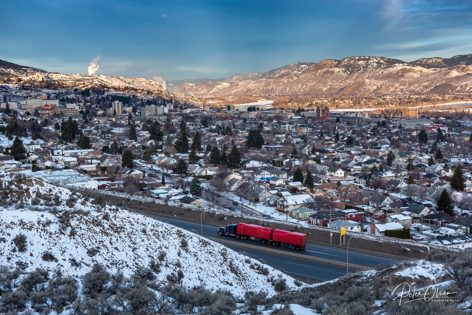 Kamloops City road with truck and city with snow-covered plants