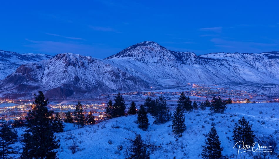 Kamloops City nighttime view with lights and snowy mountain and ground