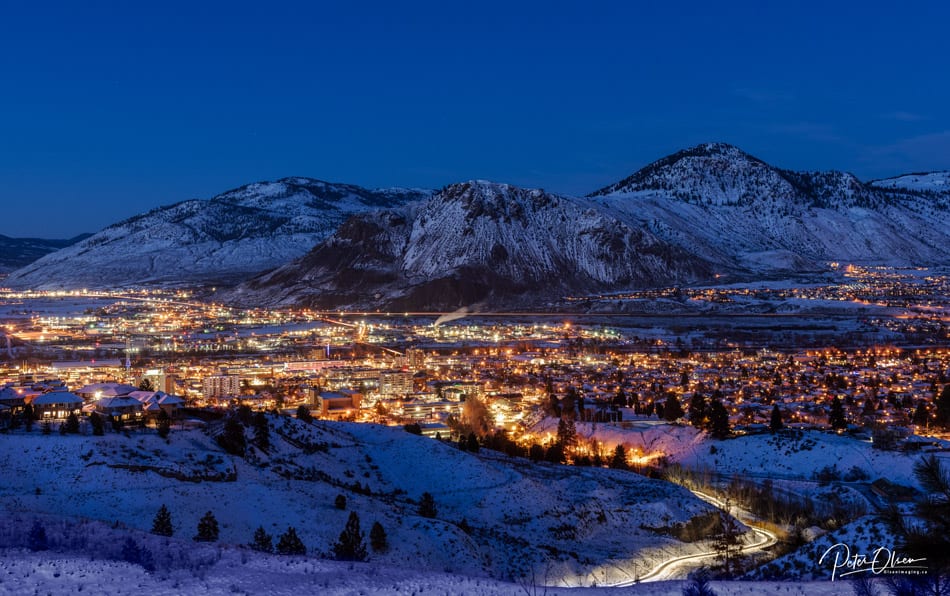 Kamloops City dark blue sky with snow-capped mountains with city lights