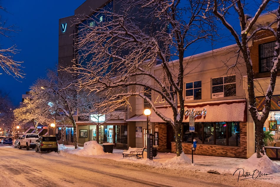 Kamloops City snow-covered ground with frosty trees and shops with lights