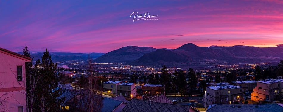 Kamloops City sunlight with purple pink and yellow sky with mountain and city lights 2