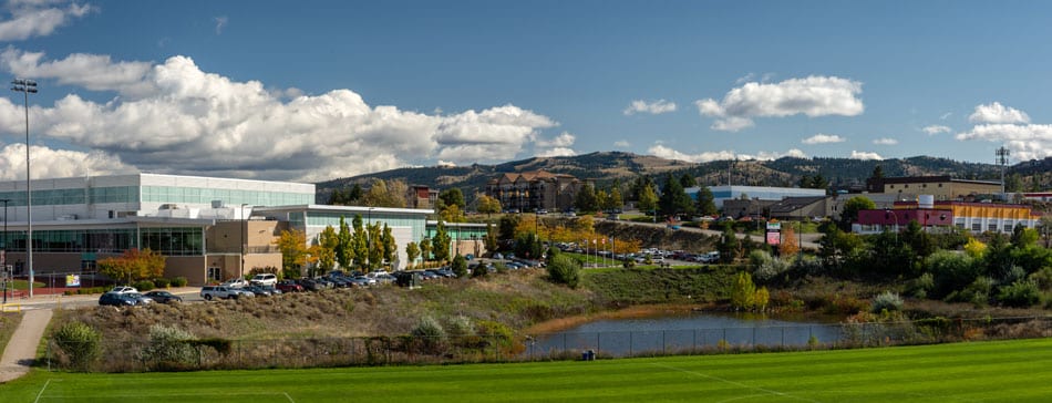 Kamloops City blue sky with white clouds and building with green lawn