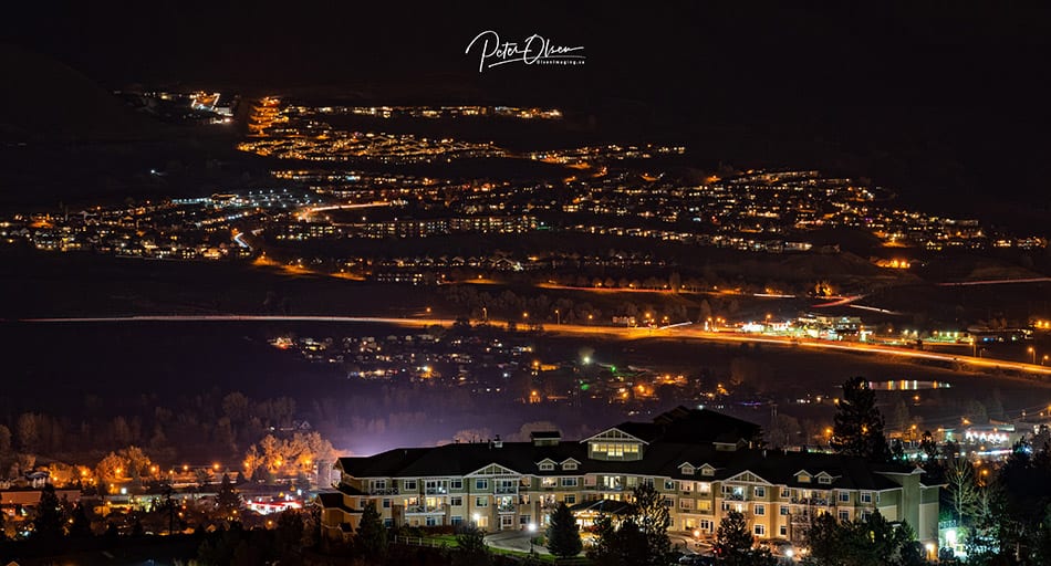 Kamloops City night sky with bright city lights and house with river