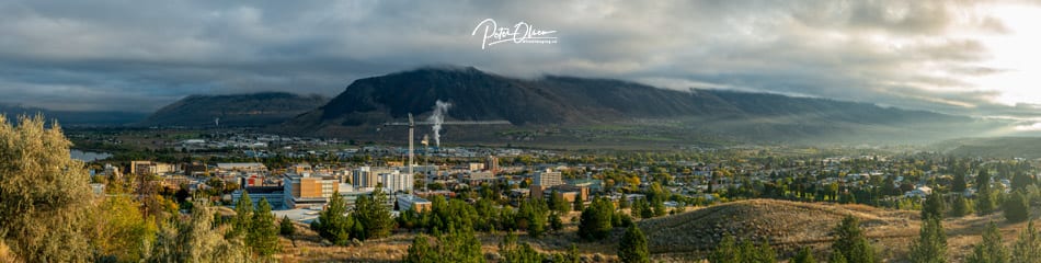 Kamloops City mountain with white clouds and trees with buildings
