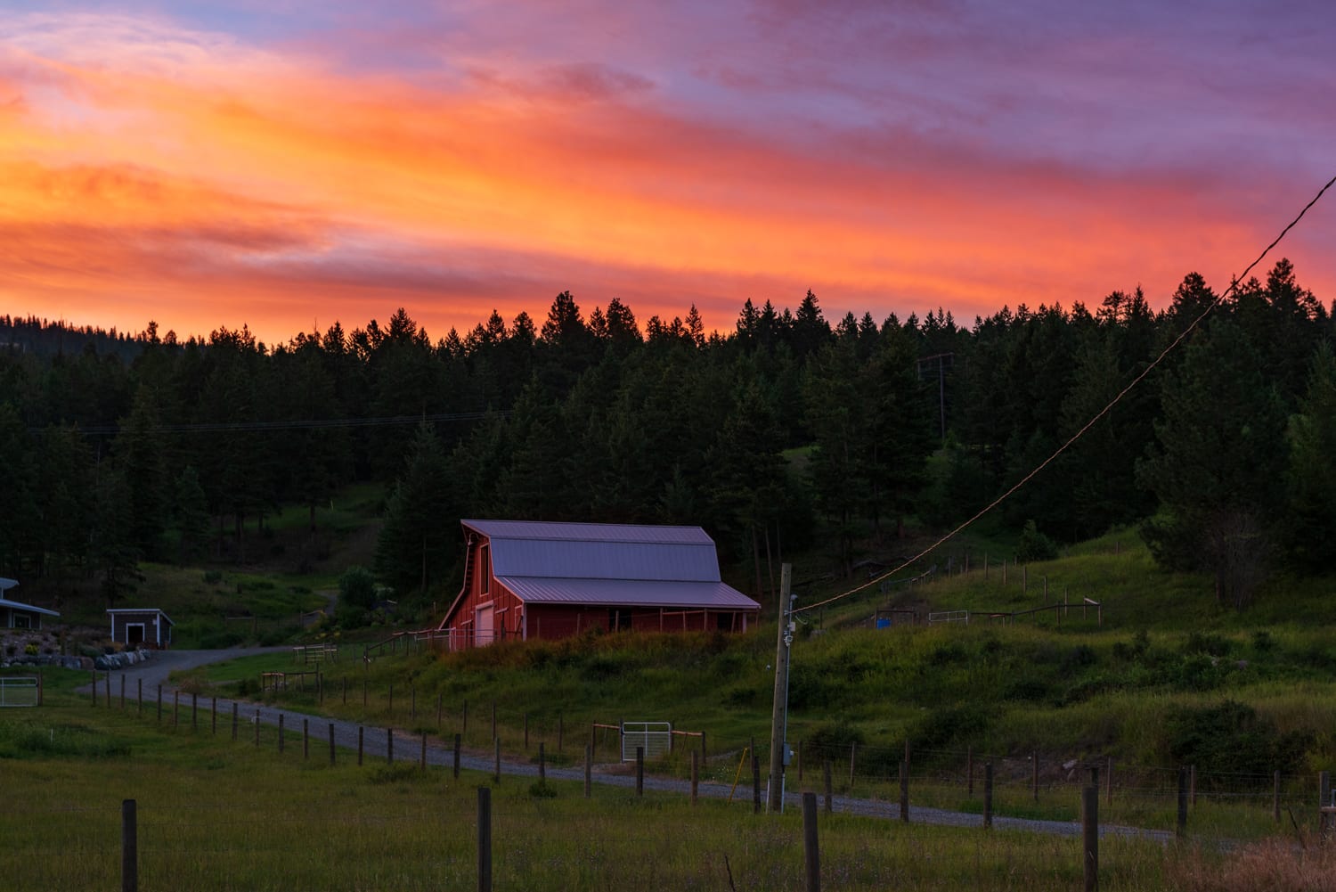Kamloops rural life red ranch with sunset and trees with wooden fences