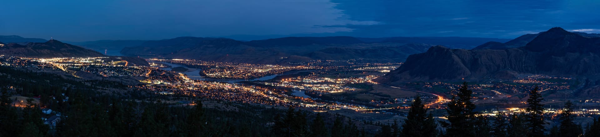 Kamloops City Aerial wide-angle view of mountains and city with lights