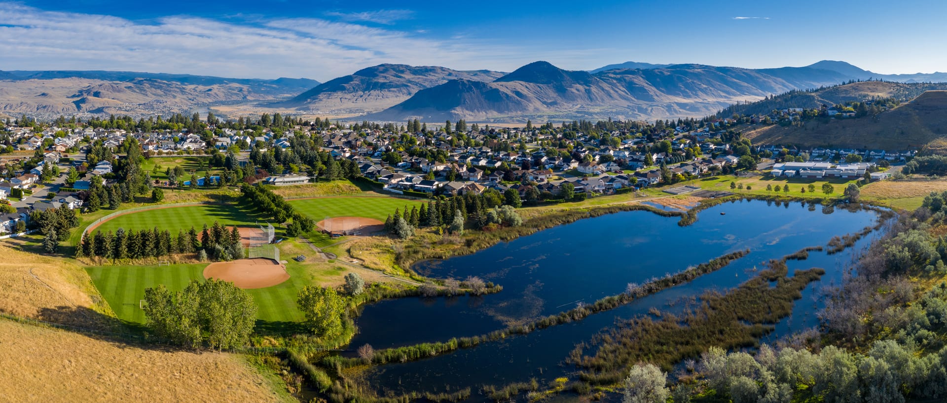 Kamloops City Aerial HDR panoramic view out mountains and rivers with lawn