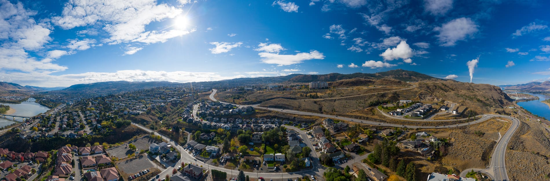 Kamloops City Aerial bright sky with clouds and winding roads with city