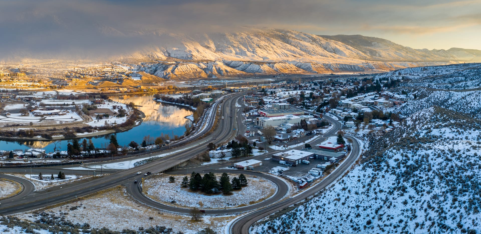 Kamloops City Aerial winding and round road with cloud covering mountain