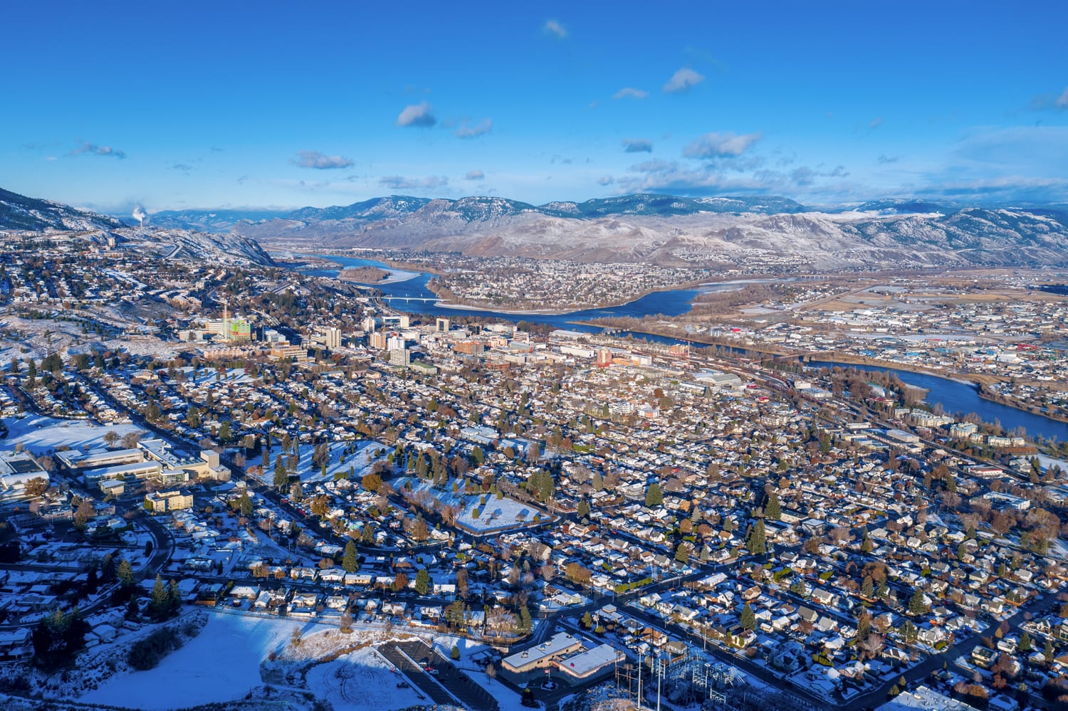 Kamloops City Aerial blue sky and dotted clouds over city and winding river