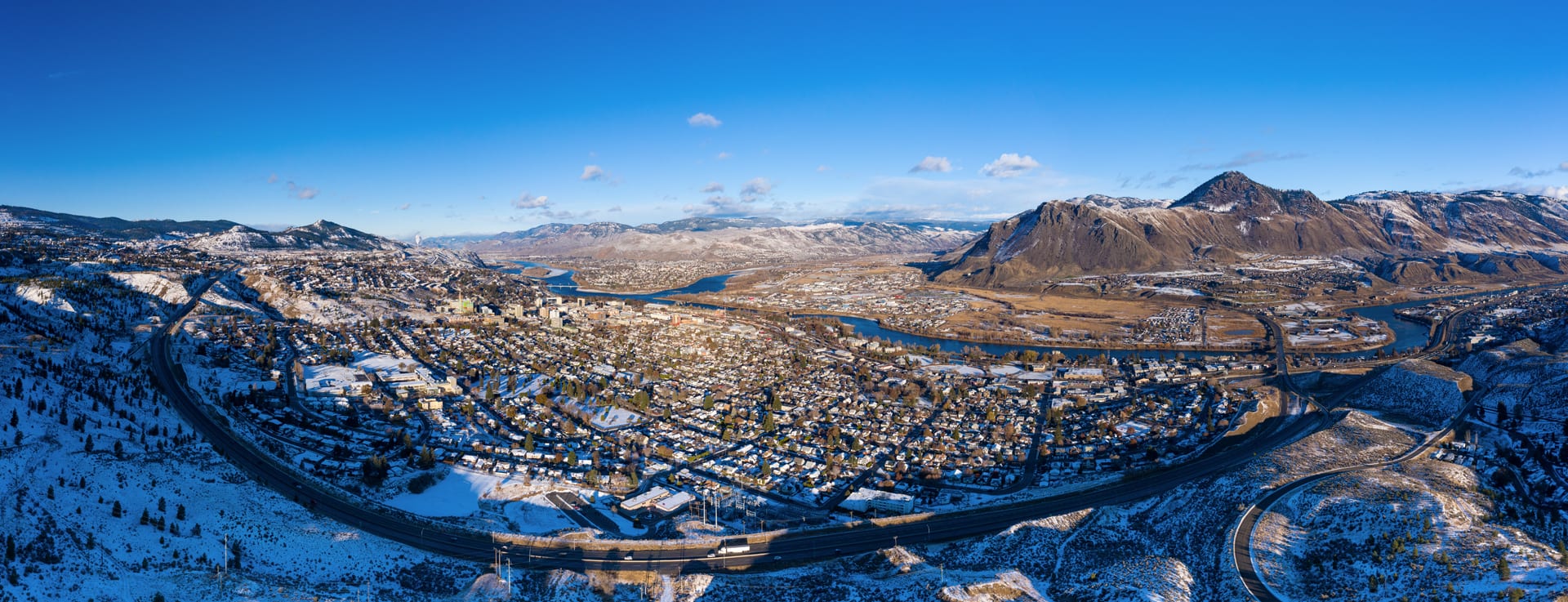 Kamloops City Aerial faraway mountain with curved road and cityscape