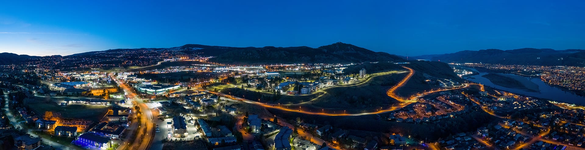 Kamloops City Aerial brightly lit roads with blue sky and cars