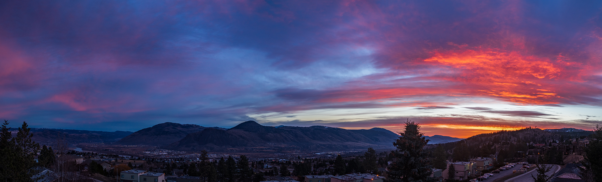 pink and red sunrise with blue sky mountain and city view