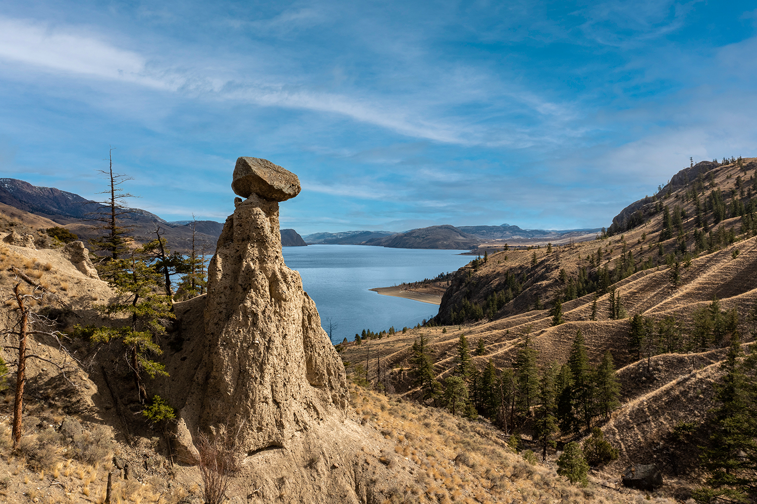 Kamloops Landscape bright blue sky with clouds and rock formation mountains