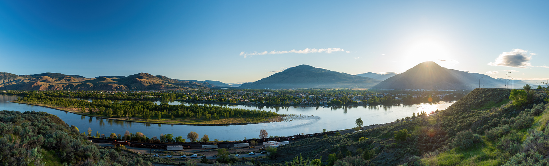 beautiful panoramic view of Kamloops City mountains and lake with sun