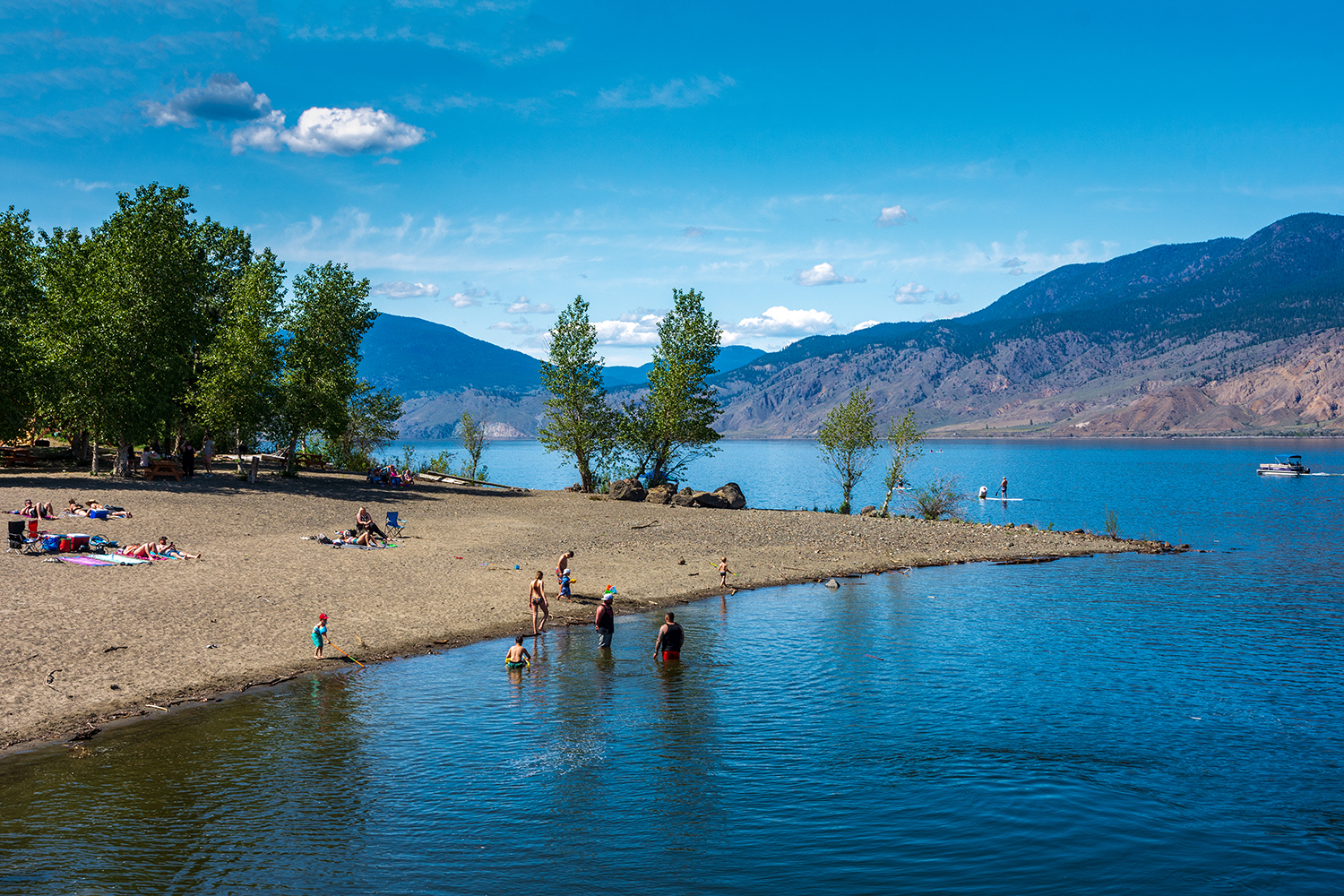 Kamloops Other beach with wide river with trees and mountain with clouds
