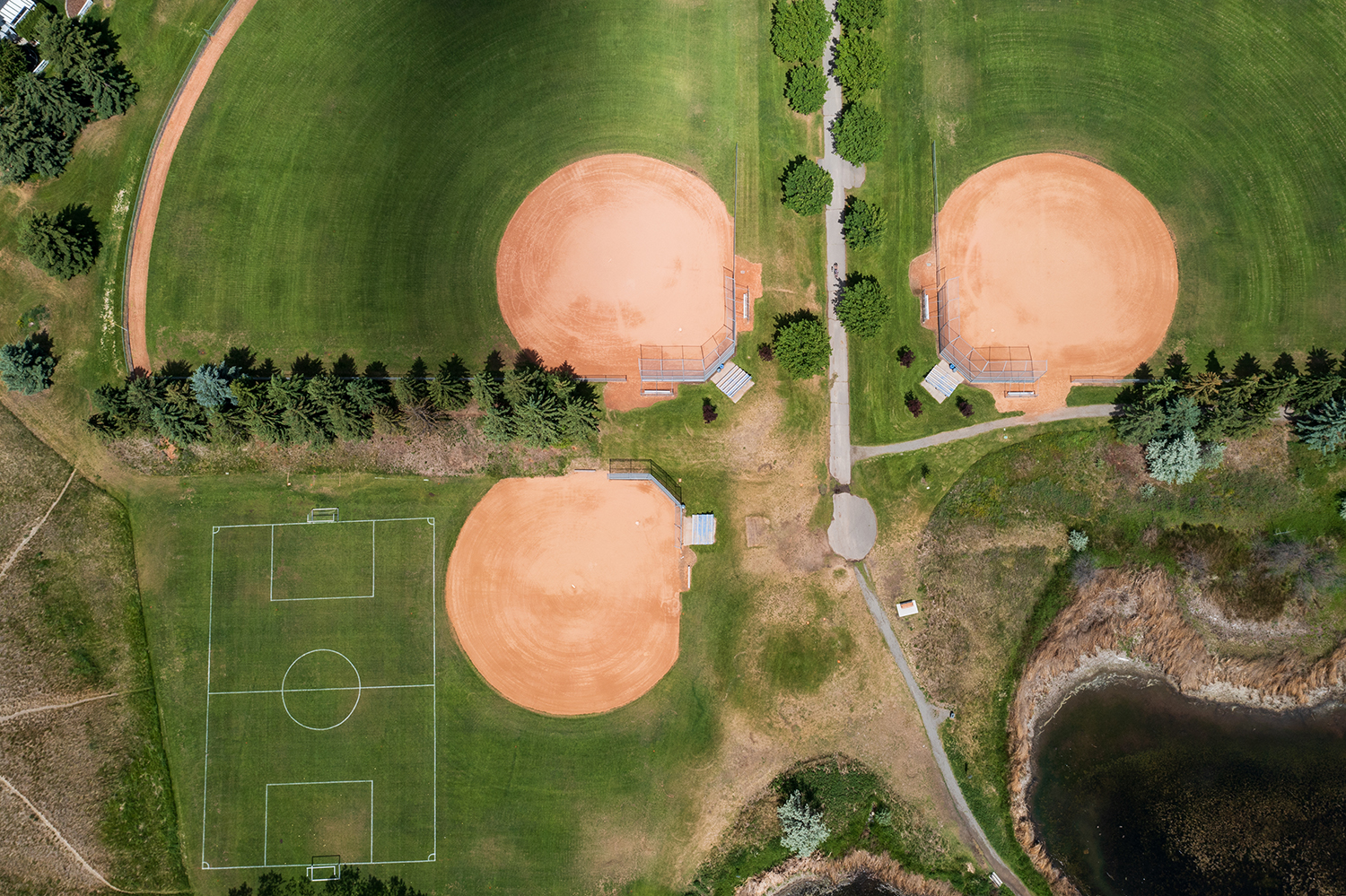 top-down view of landscaped lawn with sand pockets and soccer field