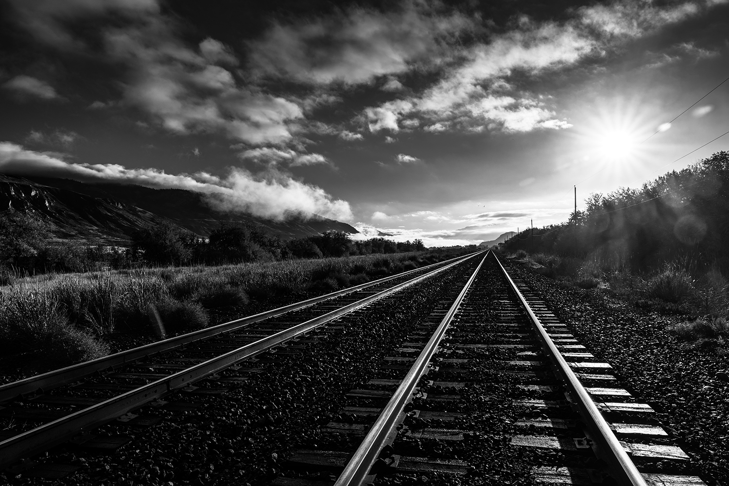 Kamloops grayscale photo with railroad tracks