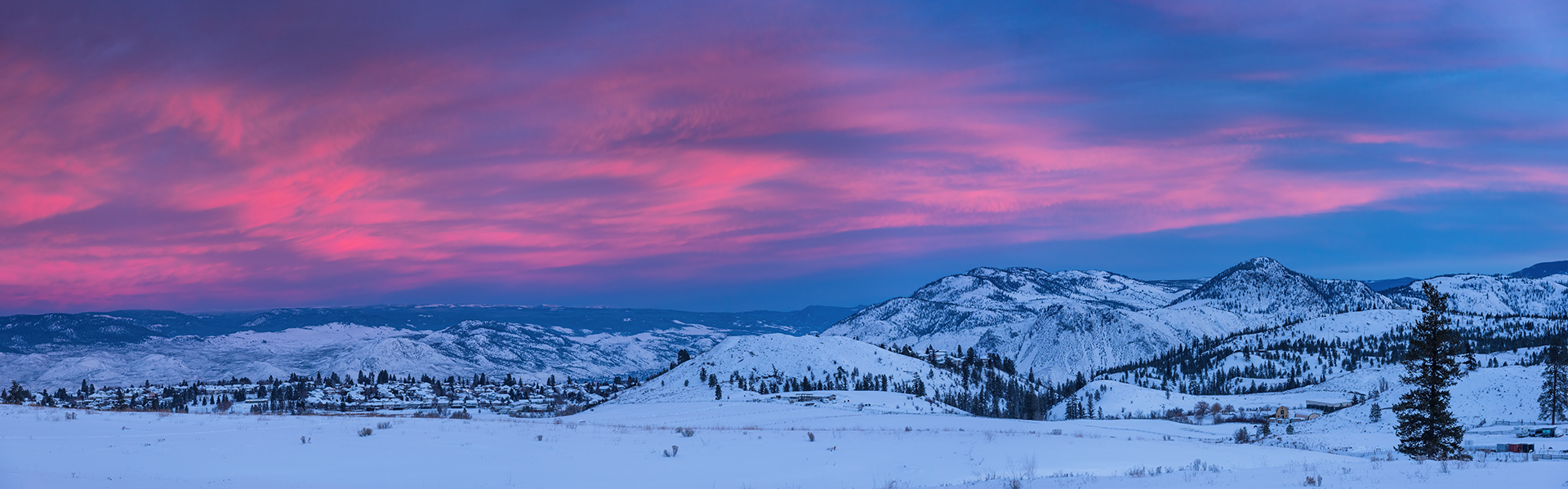 panoramic view of a blue and pink sky with snow
