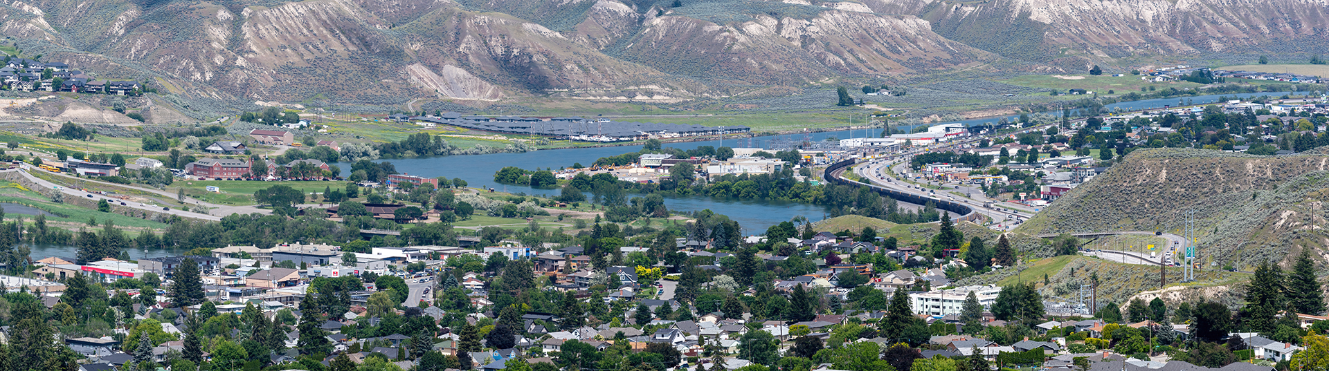 panoramic view of lakes mountains and trees across a city
