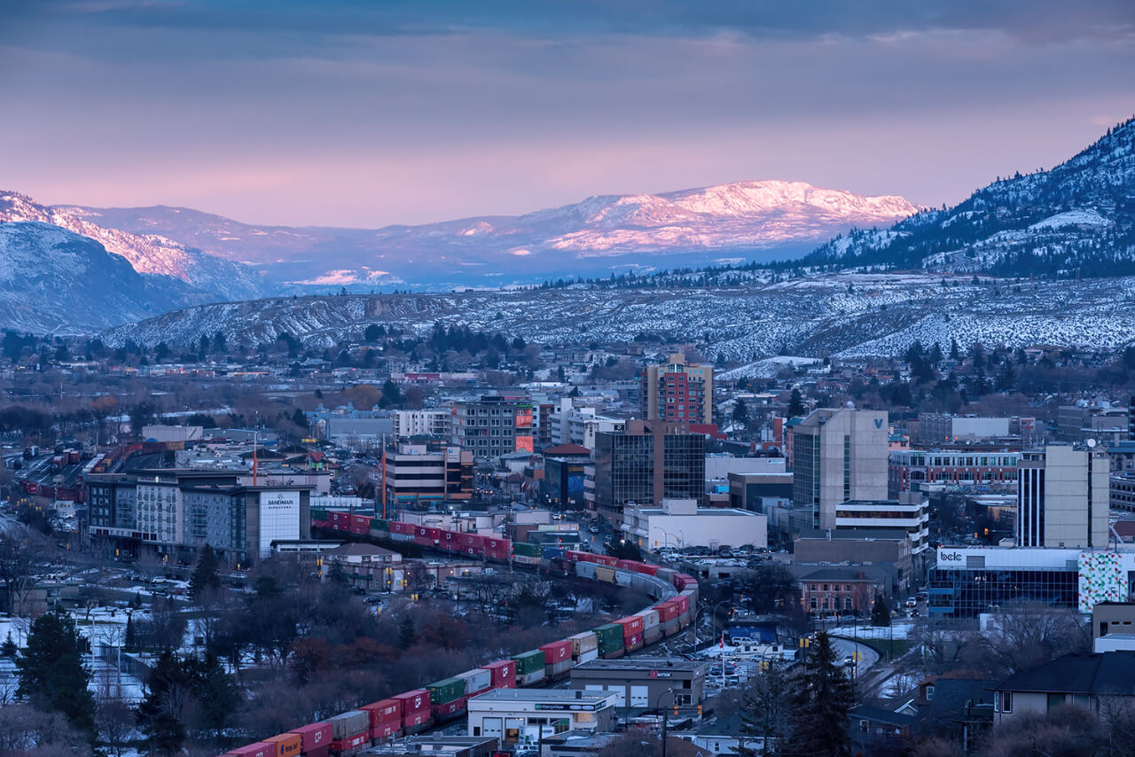 Beautiful view of the city and mountains with pale pink sky