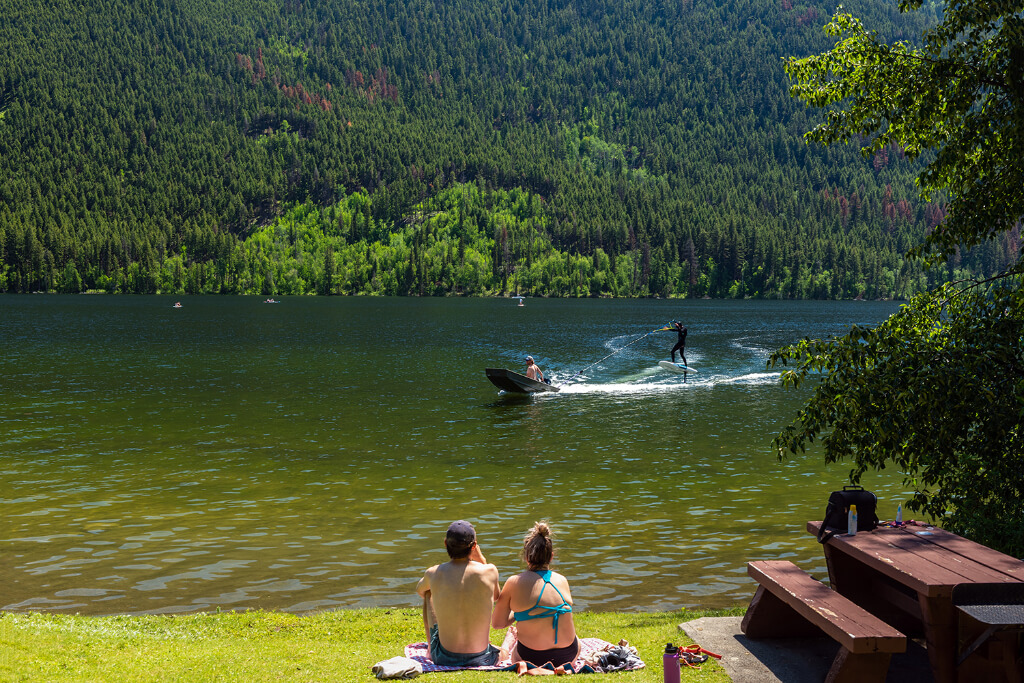 Couple looking at a person doing jet skiing