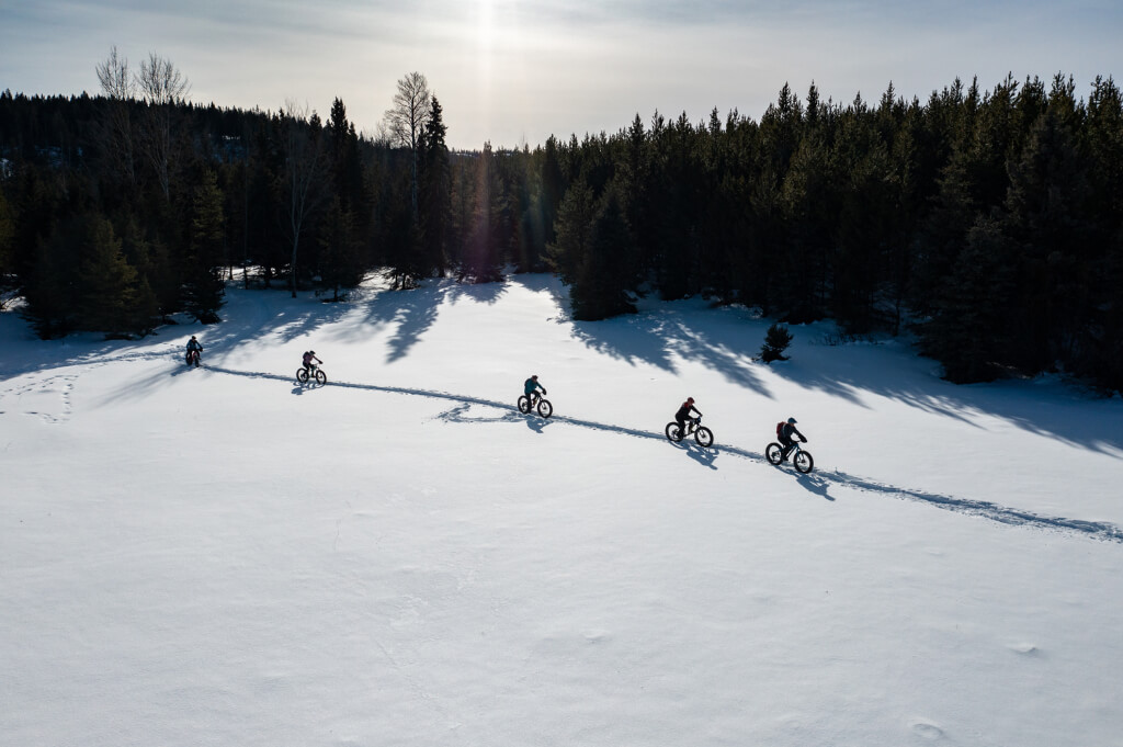 Group of people cycling on snow mountain